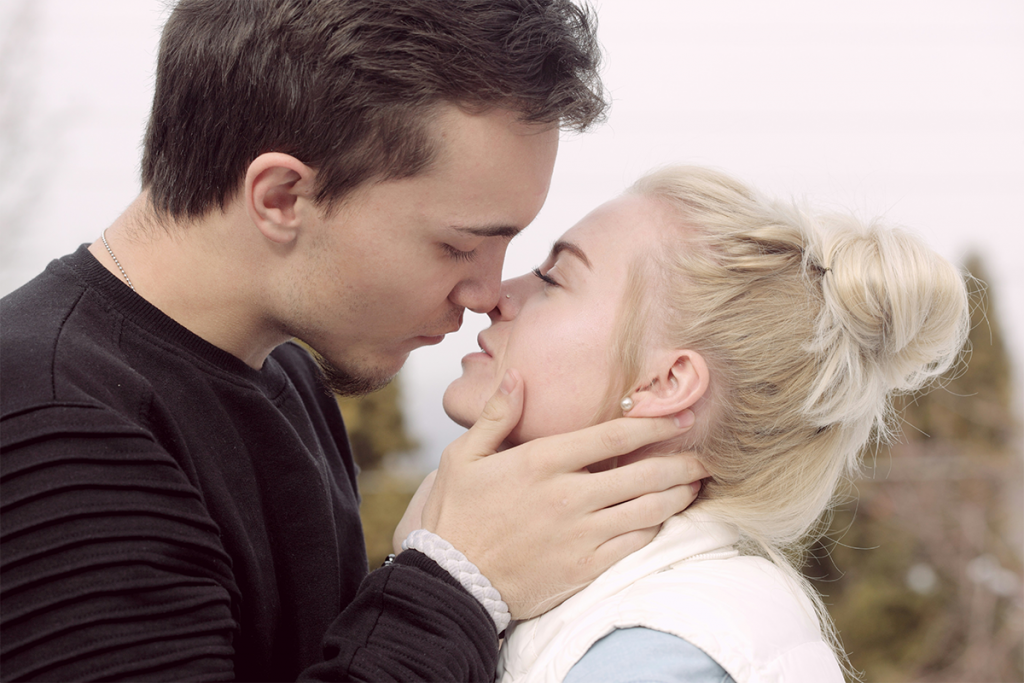 A man and a woman just about to kiss.