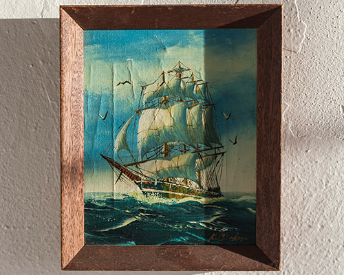 Painting of a ship in a fame.