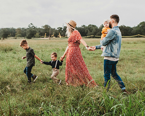 A family walking together in a field.