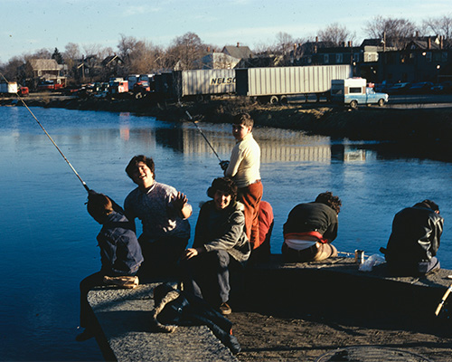 Kids fishing on a pier.