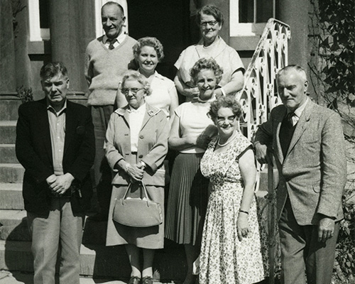  A large group of elderly people posing for a photo.